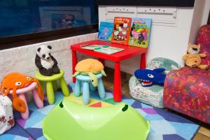 a room with a table and chairs and stuffed animals at Hotel Desiree in Lignano Sabbiadoro