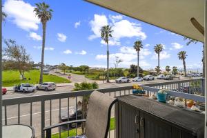 a balcony with a view of a street with palm trees at Beautiful 1 Bed Beach Balcony Condo #207 in Carpinteria +20 photos