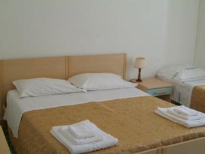 Postel nebo postele na pokoji v ubytování Hotel Aurora