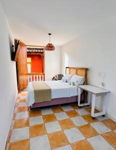 a bedroom with a bed and a tiled floor at Hostal Casa Torres Cartagena Centro Historico - Adults Only in Cartagena de Indias +91 photos