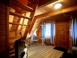 a living room with wooden walls and wooden floors at Mholiday Sarbinowo u Kaspra in Sarbinowo +1 photo