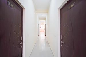 a hallway with two sets of doors in a building at Hotel O Deva road Formerly Hotel Sunrise Inn in Lucknow