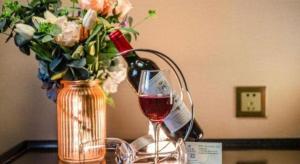 a vase of flowers and a glass of wine at Nanning Yongjiang Hotel in Nanning