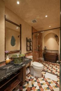 a bathroom with a toilet and a sink and a shower at Tranquility Suites Westlake in Hanoi +35 photos