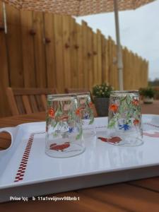 two glasses sitting on top of a table at Gîte d'Epona in Pierrefitte-en-Auge