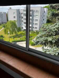 an open window with a view of a building at ZieloneMistrzejowice in Kraków