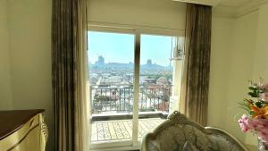 a room with a window with a view of a balcony at LK CRYSTAL Ville PATTAYA in Ban Chek