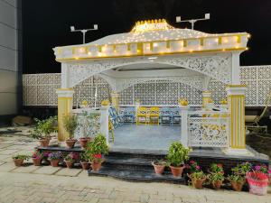 a gazebo with a table and chairs and plants at Hotel Laxmi villa in Naini