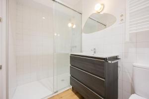 a white bathroom with a sink and a shower at Plaza Nueva in Bilbao +7 photos