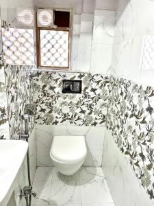 ein weißes Badezimmer mit Toilette und Waschbecken in der Unterkunft Arch Heritage in Jaipur