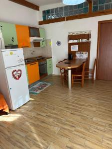 a kitchen with a table and a refrigerator at Nido d'amore a Terracina in Terracina +27 photos