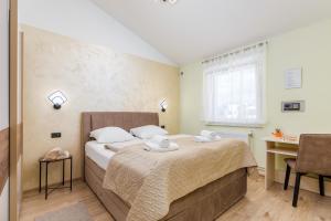 Posteľ alebo postele v izbe v ubytovaní Apartments Ana-Maria