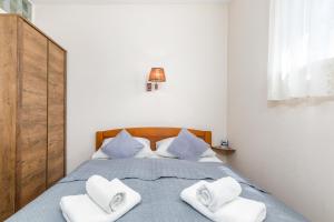 Posteľ alebo postele v izbe v ubytovaní Apartments Ana-Maria