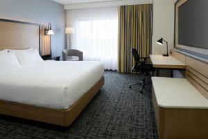 a hotel room with a bed and a desk at Fairfield Inn & Suites by Marriott Montreal Airport in Dorval