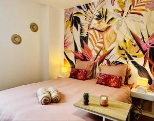 a bedroom with a large bed with a mural on the wall at L'Escali'Bulle - Entre Gare et Centre-ville in La Celle-sous-Gouzon