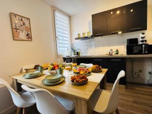 a kitchen with a wooden table with food on it at L'Escali'Bulle - Entre Gare et Centre-ville in La Celle-sous-Gouzon +20 photos