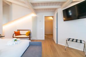 a bedroom with a bed and a tv on a wall at 650m from the sea, 8 guests, AC, Wi-Fi in Civitanova Marche