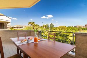 a wooden table sitting on top of a balcony at 650m from the sea, 8 guests, AC, Wi-Fi in Civitanova Marche