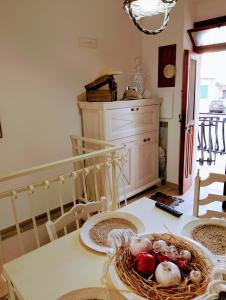 a dining room table with a basket of fruit on it at Dimora Egnazia in Savelletri di Fasano