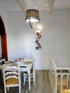 a dining room with a white table and chairs at Dimora Egnazia in Savelletri di Fasano