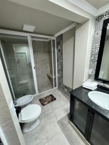 a bathroom with a toilet and a sink and a shower at Como en casa in Aguilares