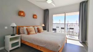 sypialnia z łóżkiem i balkonem z widokiem na okolicę w obiekcie Marbella Golf 101 By Pride Holiday Rentals w mieście Maspalomas