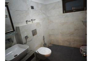 a bathroom with a white toilet and a sink at Greater Ladakh Residency in Leh +27 photos