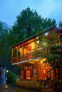 a house with a balcony on the side of it at Sony Place Villa and Resort in Kasol