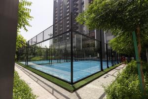 a tennis court in front of a building at Stylish Studio at Berkeley Place by Ellington in Dubai