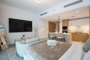 a living room with a couch and a table at Stylish Studio at Berkeley Place by Ellington in Dubai