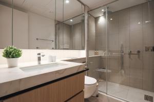 a bathroom with a sink and a shower and a toilet at Stylish Studio at Berkeley Place by Ellington in Dubai +17 photos