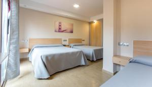 Posteľ alebo postele v izbe v ubytovaní Hotel Olympia Ronda I