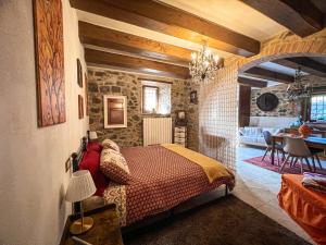 a bedroom with a bed and a dining room at L' antico lavatoio in Radicofani