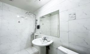 a white bathroom with a sink and a mirror at Gumi time hotel in Gumi +49 photos