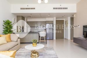 a living room with a couch and a table at Bloomfields 1BR Elegant in Shams Meera in Abu Dhabi