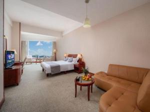 a living room with a bed and a couch at Kunming Plateau Pearl Hotel in Kunming +135 photos
