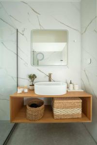 a bathroom with a sink and a mirror at Esatia Villa in Exanthia +54 photos