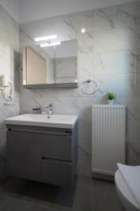 a bathroom with a sink and a mirror at Pantheon Suites Gaitis in Nafplio +28 photos