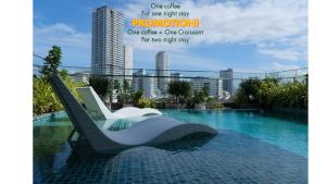 a chair sitting next to a swimming pool at Em Oi Boutique Hotel in Nha Trang