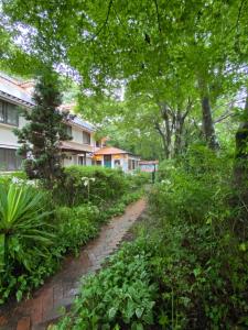 a dirt road in front of a house at Flower Garden in Takamori