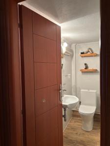 a bathroom with a door to a toilet and a sink at Soul Home in Iraklitsa +22 photos