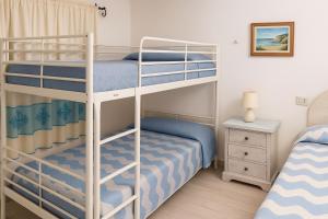 a bedroom with two bunk beds in a room at Wind Rose Exclusive -Natural pool 50 m from the Sea in Olbia +34 photos