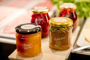 a group of three jars of honey on a table at Motel One Prague-Florentinum in Prague