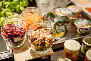 a group of jars of food on a table at Motel One Prague-Florentinum in Prague