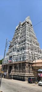 a large temple tower with a car parked in front at Sri Annai Home Stay III in Tiruvannāmalai