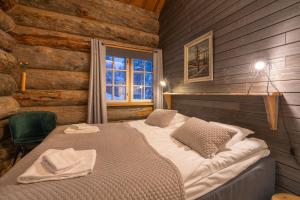 a bedroom with a bed in a room with a window at Kuukkeli Hirvas Suite in Saariselka