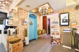 a kitchen with a blue door and two kids in a room at Daegu February Hotel Suseong in Daegu +87 photos