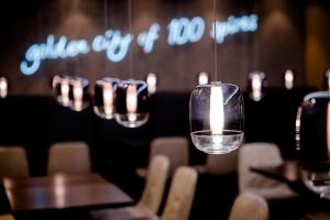 a row of wine glasses sitting on a table at Motel One Prague-Florentinum in Prague