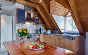 a kitchen with a bowl of fruit on a wooden table at Gasthof Schweizerhof in Villingen-Schwenningen