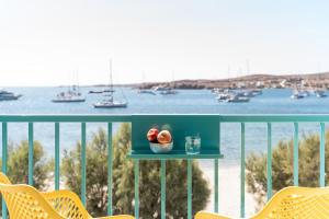 a table with a bowl of fruit on a balcony overlooking the water at Play Paros in Kampos Paros